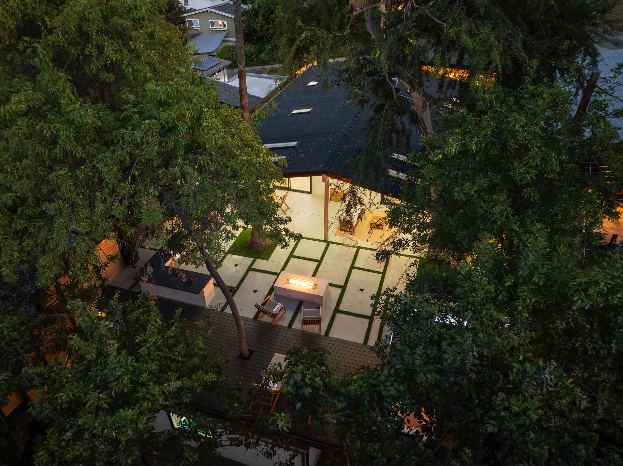 Primary suite with continuous wood floors, linear gas fireplace, and direct backyard access.