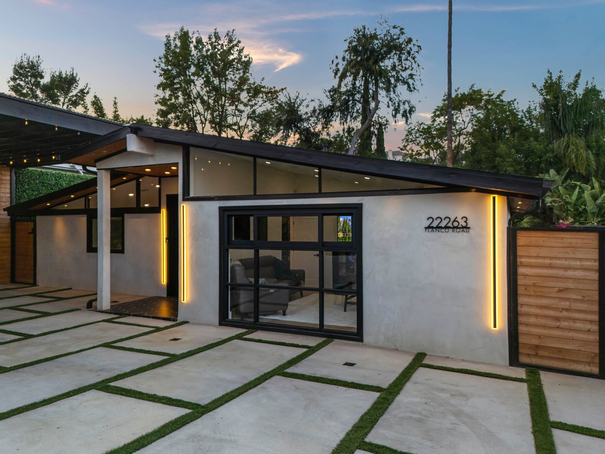 Covered outdoor lounge with built-in heaters, sound system, and retractable shade.